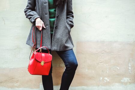 Long hair brunette girl near old wall with red backpackの写真素材