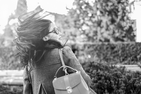 Woman with streaming hair outdoor on the street, black and whiteの写真素材
