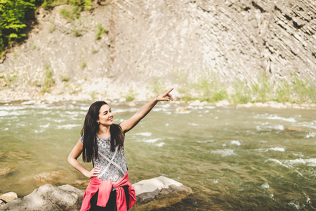 Girl near mountain riverの写真素材