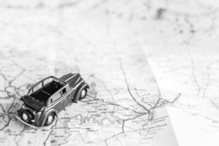 Toy retro car on the map, travel concept, black and whiteの写真素材