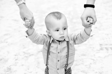 Young happy parents playing with little son outdoor in the park, black and whiteの写真素材
