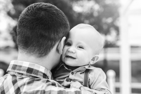 Young father with his little son have fun outdoor in the park, black and whiteの写真素材