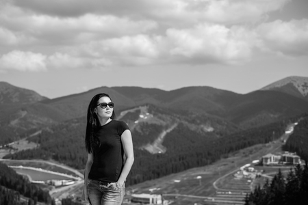 Tourist girl enjoy nature on the top of the mountain, black and whiteの写真素材
