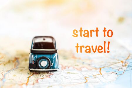 Toy vintage car on the map with travel motivationの写真素材