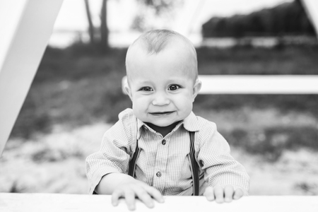 Cute little boy playing outdoor in the park, black and whiteの写真素材