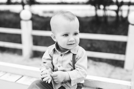 Cute little boy playing outdoor in the park, black and whiteの写真素材