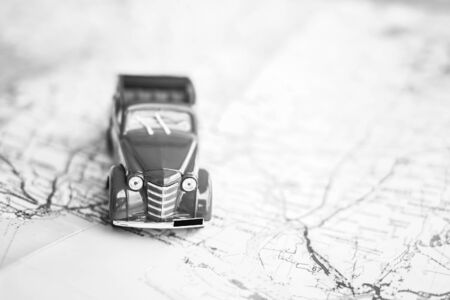 Toy car on the map, travel concept, black and whiteの写真素材