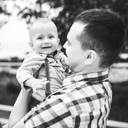Young father with his little son have fun outdoor in the park, black and white