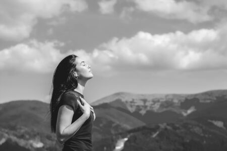 Long hair brunette girl on the top of the mountain enjoying fresh air, black and whiteの写真素材