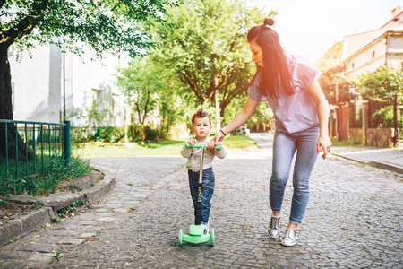 Young mother with her little son outdoor in the parkの写真素材