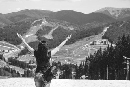 Tourist girl enjoy nature on the top of the mountain, black and whiteの写真素材