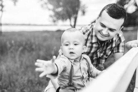Young father with his little son have fun outdoor in the park, black and whiteの写真素材