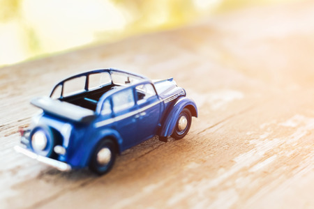 Toy vintage cabrio car on wooden backgroundの写真素材