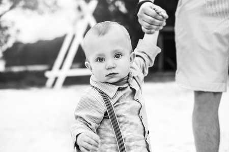 Young father with his little son have fun outdoor in the park, black and whiteの写真素材