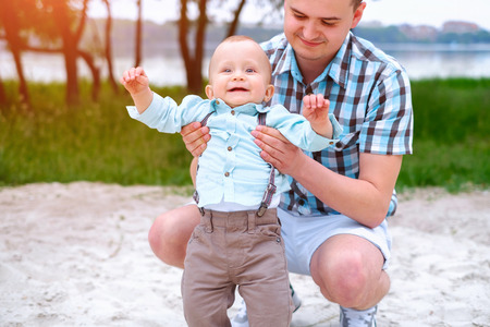 Young father with his little son have fun outdoor in the parkの写真素材