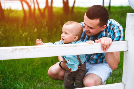 Young father with his little son have fun outdoor in the parkの写真素材