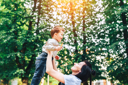 Young mother with her little son outdoor in the parkの写真素材