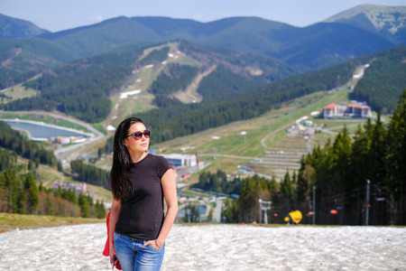 Tourist girl enjoy nature on the top of the mountainの写真素材