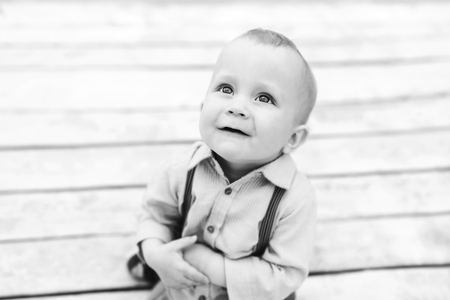 Cute little boy playing outdoor in the park, black and whiteの写真素材