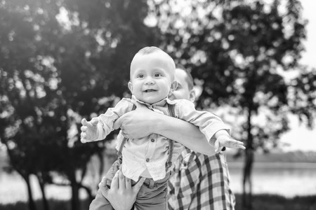 Young father with his little son have fun outdoor in the park, black and whiteの写真素材