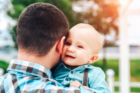 Young father with his little son have fun outdoor in the parkの写真素材