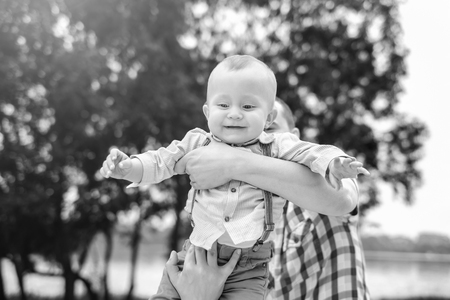 Young father with his little son have fun outdoor in the park, black and whiteの写真素材