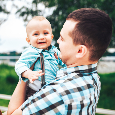 Young father with his little son have fun outdoor in the parkの写真素材
