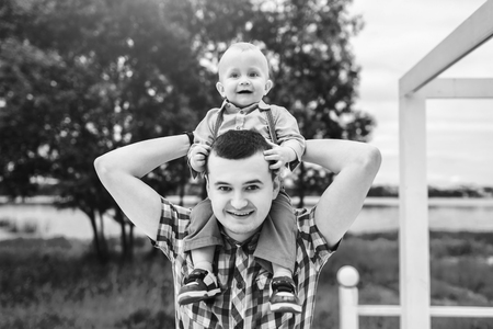 Young father with his little son have fun outdoor in the park, black and whiteの写真素材