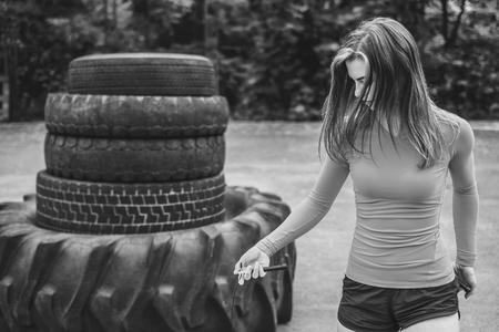 Pretty sporty girl with rope training outdoor, black and whiteの写真素材
