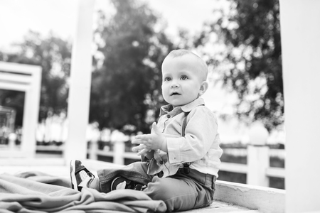 Cute little boy playing outdoor in the park, black and whiteの写真素材