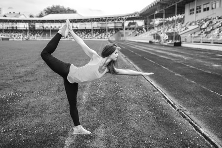 Pretty young brunette sporty girl workout outdoor, black and whiteの写真素材