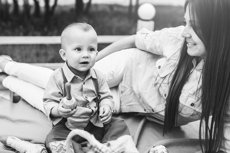 Young happy mother with her little son playing outdoor, black and whiteの写真素材