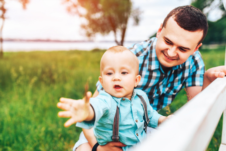 Young father with his little son have fun outdoor in the parkの写真素材