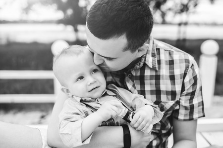 Young father with his little son have fun outdoor in the park, black and whiteの写真素材