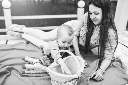Young happy mother with her little son playing outdoor, black and whiteの写真素材