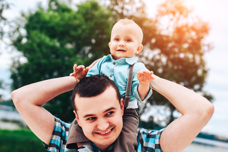 Young father with his little son have fun outdoor in the parkの写真素材