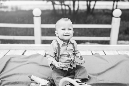 Cute little boy playing outdoor in the park, black and whiteの写真素材