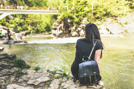 Tourist girl enjoy nature near mountain riverの写真素材