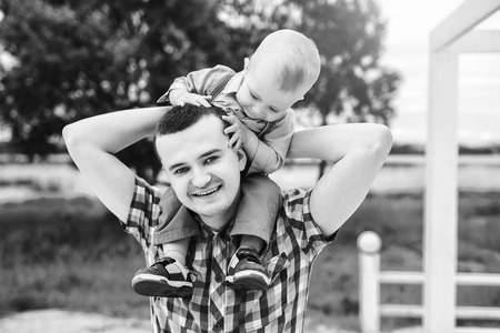 Young father with his little son have fun outdoor in the park, black and whiteの写真素材