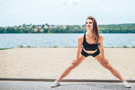 Pretty young brunette sporty girl workout outdoorの写真素材