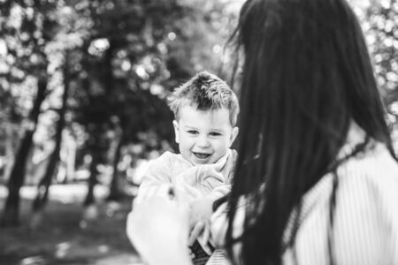 Young mother with her little son outdoor in the park, black and whiteの写真素材