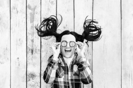 Young happy brunette girl lying on wooden backround, black and  whiteの写真素材