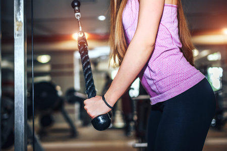 Pretty sporty girl training in the gym