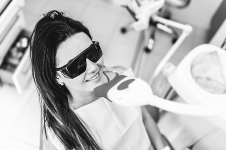 Teeth whitening in dental clinic for female patientの写真素材