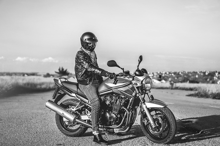Biker on sport motorcycle outdoor on the roadの写真素材