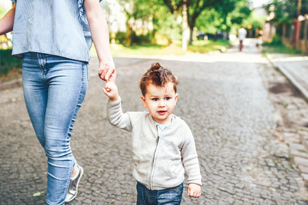 Young mother with her little son outdoor in the parkの写真素材