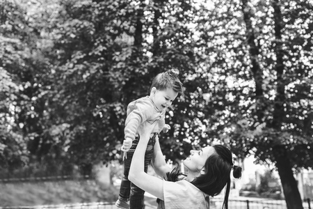 Young mother with her little son outdoor in the park, black and whiteの写真素材