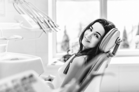 Happy dental patient in the dental chair, black and whiteの写真素材