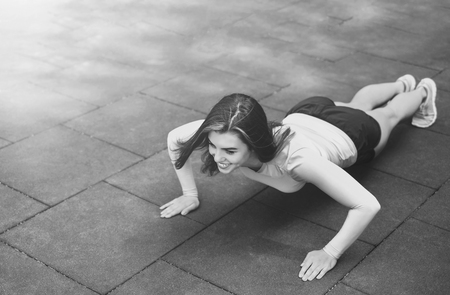 Pretty young brunette sporty girl workout outdoor, black and whiteの写真素材