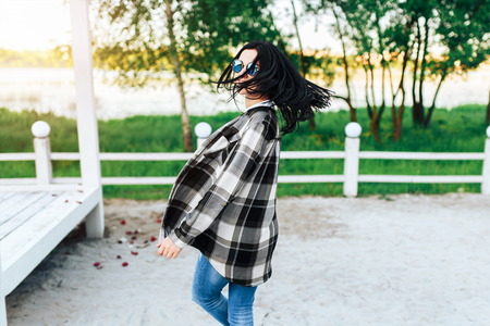 Pretty brunette girl have fun outdoor in the parkの写真素材